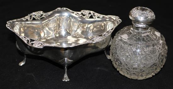 An Edwardian Art Nouveau silver bon bon dish and a cut glass silver topped scent bottle.